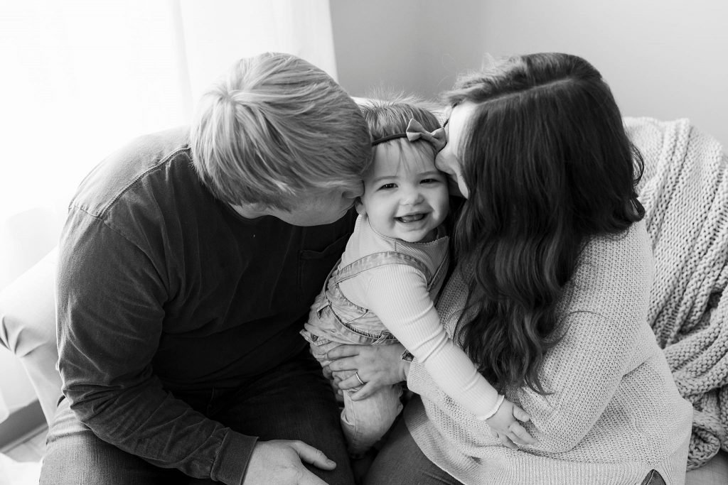 One year old girl and family